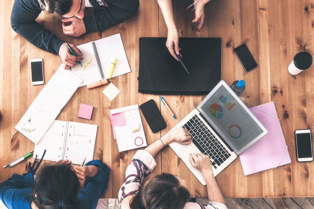 overhead view on business people around desk